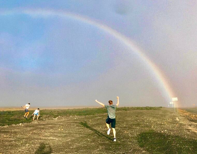 People chasing after a rainbow