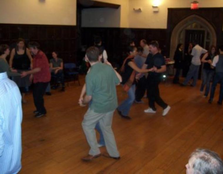 Students swing-dancing in pairs.