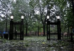 The gates to Calhoun Residential College and a courtyard strewn with fallen branches.