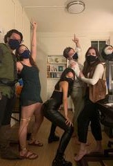 5 people pose in masks