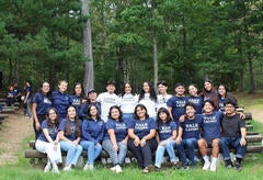Image of students in "Yale Latinx" shirts posing together during La Casa retreat