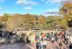 A bustling, sunny day at the Bethesda Fountain in NYC's Central Park