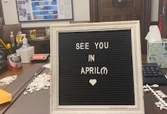 a sign reading "See You In April(?)"
