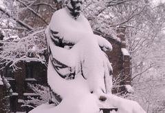 A statue on campus, unrecognizable beneath a thick covering of snow.
